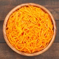 Carrot cut in julienne, salad in wooden bowl