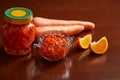 Carrot jam in a jar and bowl, Carrots, mandarin slices for decoration