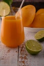 Carrot juice macro with lime slice on white vintage wooden desktop Royalty Free Stock Photo