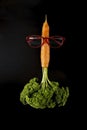 carrot looking like a rocket with eye glasses and parsley flames, launching.