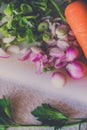 Carrot and other vegetables on white cutting board Royalty Free Stock Photo