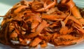 Carrot peelings are on a white plate, preparation for fermentation, zero waste concept.