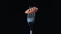 Carrot slice on a fork against black background Royalty Free Stock Photo