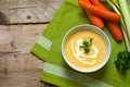 Carrot soup with cream, parsley garnish and celery in a bowl on Royalty Free Stock Photo