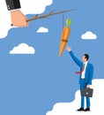 Carrot on a stick in hand and businessman. Royalty Free Stock Photo