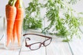 Carrot vitamin A and eyeglasses help your eyes medical concept.