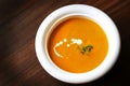 Carrot and yam creamy soup with cream and thyme