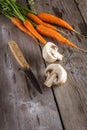 Carrots and champignon on old boards