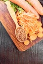 Carrots dried in spoon on dark board top