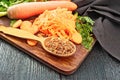 Carrots dried in spoon on dark board