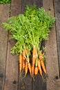 Carrots after garthering over wooden background, roustic style Royalty Free Stock Photo