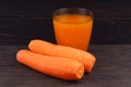 Carrots and juice in a glass black background Royalty Free Stock Photo