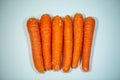 Carrots in a row, funny carrots, white background Royalty Free Stock Photo