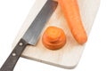 Carrots slice and knife on cutting board on white backg