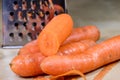 Carrots take off on a kitchen grater. Kitchen countertop and preparation of salads.