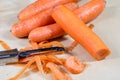 Carrots take off on a kitchen grater. Kitchen countertop and preparation of salads.