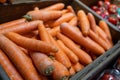 Carrots in a wooden box in a grocery store. Sale of carrots, selective focus.