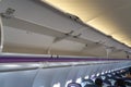 Carry-on luggage in overhead storage compartment on commercial airplane
