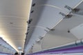 Carry-on luggage in overhead storage compartment on commercial airplane Royalty Free Stock Photo