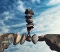 Man carries a stack of stones on a unstable path between