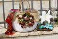 Carrying bag made of raffia braided with floral decoration, light blue flip flops and a white lily flower, set off on a brick wall Royalty Free Stock Photo