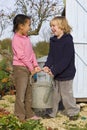 Mixed Race Children Gardening Holding Watering Can Royalty Free Stock Photo