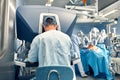 Carrying out an operation using a robot, a robot surgeon with manipulators, a modern operating room, surgeons people