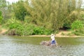 Carrying sugarcane by a bamboo raft