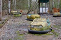 Cars in an abandoned amusement park in Pripyat. Rusty deserted attractions