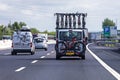 cars with attached pleasure bikes drive along the road