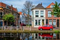 Cars on canal embankment in street of Delft. Delft, Netherlands Royalty Free Stock Photo