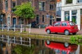 Cars on canal embankment in street of Delft. Delft, Netherlands Royalty Free Stock Photo