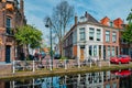 Cars on canal embankment in street of Delft. Delft, Netherlands Royalty Free Stock Photo