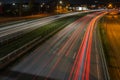 Cars blurred lighting traces on night on roadway from Riga to resort city Jurmala