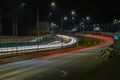 Cars blurred lighting traces on night on roadway from Riga to resort city Jurmala