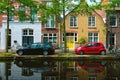 Cars on canal embankment in street of Delft. Delft, Netherlands Royalty Free Stock Photo