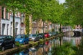 Cars on canal embankment in street of Delft. Delft, Netherlands Royalty Free Stock Photo