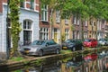 Cars on canal embankment in street of Delft. Delft, Netherlands Royalty Free Stock Photo