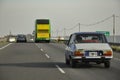 Cars and a colourful bus driving on the Argentinian motorway highway next to the sea (Autovia 2, Mar del Plata, Argentina -