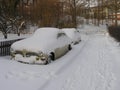 Cars covered in snow on a street in town in Karlskrona