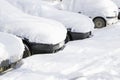 Cars covered with snow.