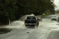 Cars crossing flooded road