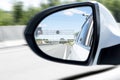 Cars drive along a high road with motion blur background. Sar side mirror with traffic. Car rear view mirror with reflection of Royalty Free Stock Photo