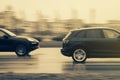 Cars drive at high speed on wet roads in the rain. Speeding, overtaking, dangerous driving on slippery asphalt. Motion blur. Riga