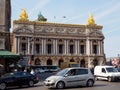 Cars drive past Palais Garnier opera house, Paris, France Royalty Free Stock Photo