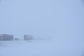 Cars drive on a winter snowy road in dense fog Royalty Free Stock Photo