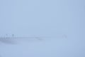 Cars drive on a winter snowy road in dense fog Royalty Free Stock Photo