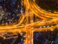 Cars driving on bridge roads shaped curve highways with skyscraper buildings. Aerial view of Expressway Bangna, Klong Toey in