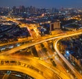 Cars driving on bridge roads shaped curve highways with skyscraper buildings. Aerial view of Expressway Bangna, Klong Toey in