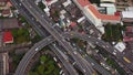 Cars driving on bridge roads shaped curve highways with skyscraper buildings. Aerial view of Expressway Bangna, Klong Toey in